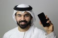 A Happy Arab Man Holding A Mobile Phone