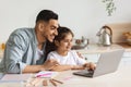 Happy arab single father helping daughter with homework Royalty Free Stock Photo