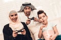 Happy Arabian Family Playing on Console at Home.