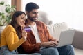 Happy Arabic Buyers Couple Shopping Online Via Laptop At Home Royalty Free Stock Photo