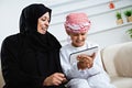 Happy Arabic child at home with his mother