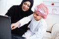 Happy Arabic child at home with his mother