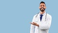 Happy Arabic Doctor Man Smiling Showing Copy Space, Blue Background