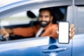 Happy Arabic Guy Sitting Inside Car Displaying Smartphone Empty Screen