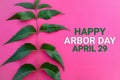 Happy Arbor Day April 29 with green leaves on a pink