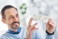 Happy architect holding a model of a house