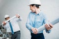 happy architects fighting with rolled building plans Royalty Free Stock Photo