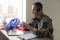 Happy army soldier having video call over laptop