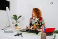 Happy artist woman painting behind work desk on graphics tablet with stylus Royalty Free Stock Photo