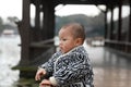 Happy Asia Chinese adorable cute toddler baby boy son child stand on bridge have fun enjoy sunny outdoor carefree nature spring Royalty Free Stock Photo