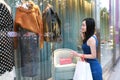 Happy Asia Chinese Eastern oriental young trendy woman girl shopping in mall with bags look at shopping window on street city Royalty Free Stock Photo