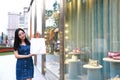 Happy Asia Chinese Eastern oriental young trendy woman girl shopping in mall with bags look at shopping window on street city Royalty Free Stock Photo