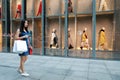 Happy Asia Chinese Eastern oriental young trendy woman girl shopping in mall with bags shopping window background on street city Royalty Free Stock Photo