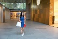 Happy Asia Chinese Eastern oriental young trendy woman girl shopping in mall with bags shopping window background on street city Royalty Free Stock Photo