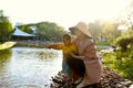 Happy Asia Chinese little boy toddler child play with his mother mom by lake holding string net catch fish carefree childhood Royalty Free Stock Photo