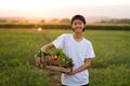 Happy asia farmer smiling and hold full basket of organic vegetable