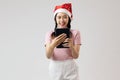 Happy asia girl in pink turtleneck using tablet Royalty Free Stock Photo