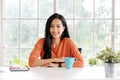 Happy asia girl, Portrait of young asian woman smiling and looking at camera in casual lifestyle while sitting at home office Royalty Free Stock Photo