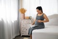 Happy Asia pregnant woman reading book and sitting on white bed Royalty Free Stock Photo