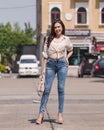 Happy Asia woman in bright blue skinny jeans, sky blue jeans