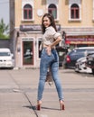 Happy Asia woman in bright blue skinny jeans, sky blue jeans