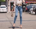 Happy Asia woman in bright blue skinny jeans, sky blue jeans