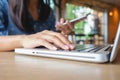 Happy Asia woman doing shopping online and use laptop shopping Royalty Free Stock Photo