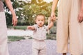 Happy asian baby boy learning to walk first steps with motherhelp at outdoor Royalty Free Stock Photo