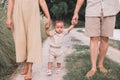 Happy asian baby boy learning to walk first steps with mother and father help at outdoor Royalty Free Stock Photo
