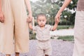 Happy asian baby boy learning to walk first steps with mother help at outdoor Royalty Free Stock Photo