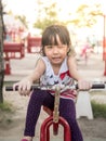 Happy asian baby child playing on playground, wink action Royalty Free Stock Photo