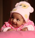 Happy asian baby girl in pink winter cap