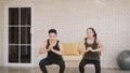 Family couple doing YOGA standing meditating on exercise sitting squat Royalty Free Stock Photo