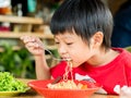 Happy Asian boy eating Royalty Free Stock Photo