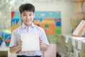 Happy asian boy hand holding blank paper board and looking at ca Royalty Free Stock Photo
