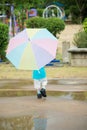 Happy asian boy holding colorful umbrella playing Royalty Free Stock Photo