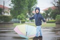 Happy asian boy holding colorful umbrella playing in the park Royalty Free Stock Photo