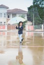 Happy asian boy holding colorful umbrella playing in the park Royalty Free Stock Photo