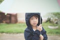 Happy asian boy holding colorful umbrella playing in the park Royalty Free Stock Photo