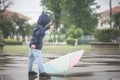 Happy asian boy holding colorful umbrella playing in the park Royalty Free Stock Photo