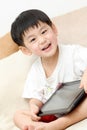 Happy Asian boy with Ipad Royalty Free Stock Photo