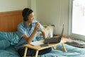 Happy asian boy laughing while using laptop Royalty Free Stock Photo