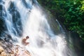 Happy asian boy playing in freshwater of tropical waterfall in summer Royalty Free Stock Photo