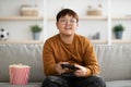 Happy asian boy playing handheld video game at home Royalty Free Stock Photo