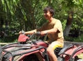 Happy asian boy on quad bike atv Royalty Free Stock Photo