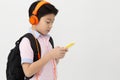 Happy Asian boy ware headphone and playing the cell phone . Royalty Free Stock Photo