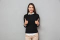 Happy asian business woman in business clothes showing thumbs up