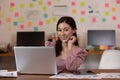 Happy Asian business woman in casual working with laptop and smile looking at camera at modern office Royalty Free Stock Photo