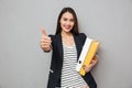 Happy asian business woman holding folders and showing thumb up Royalty Free Stock Photo