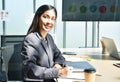 Happy Asian business woman note on book and working in office Royalty Free Stock Photo